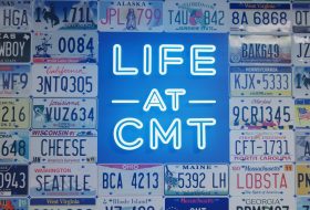 Neon LIFE sign in the center surrounded by a collage of colorful US license plates on a blue background.
