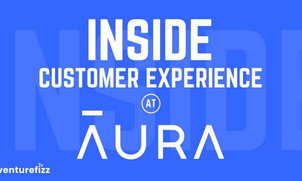 Blue banner with bold white text reading 'INSIDE CUSTOMER EXPERIENCE AT AURA' and VentureFizz logo in the bottom-left.
