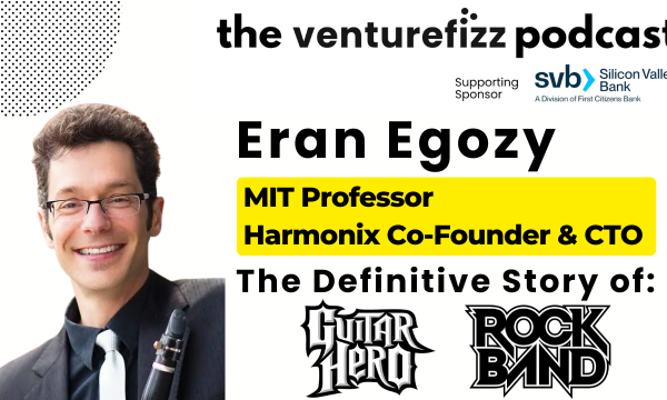 Poster-style image of Eran Egozy, MIT professor and Harmonix co-founder, with bold title text announcing the definitive story of Guitar Hero and Rock Band, including a yellow highlight behind the subtitle and sponsor logos in the header.
