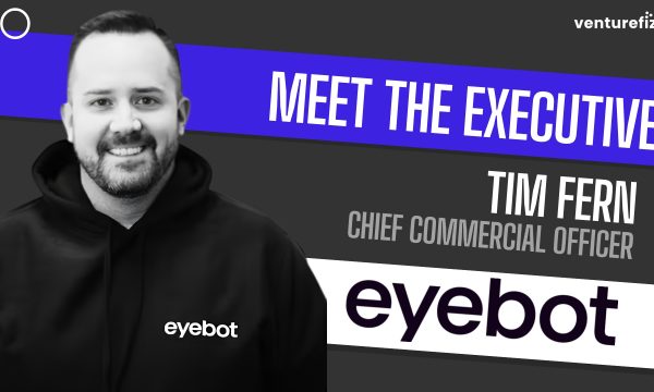 Portrait of Tim Fern, Chief Commercial Officer, smiling in a black hoodie with the eyobot logo, against a bold 'Meet the Executive' banner背景.